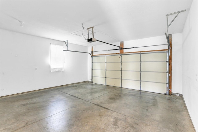 garage with a garage door opener and baseboards