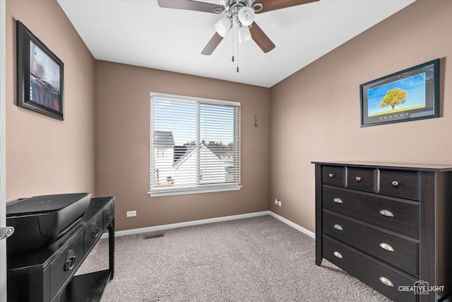interior space with a ceiling fan, light colored carpet, and baseboards