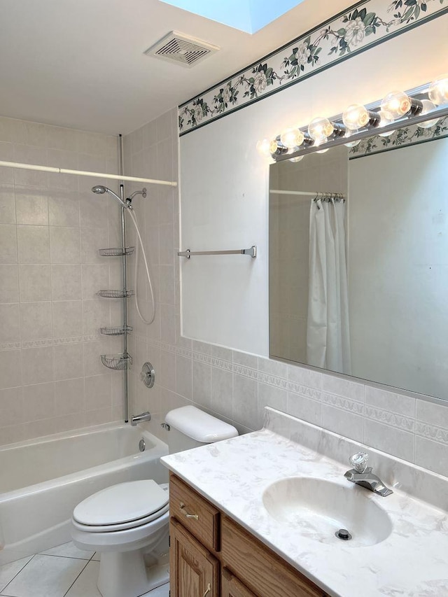 full bathroom with tile patterned flooring, vanity, shower / tub combo, tile walls, and visible vents