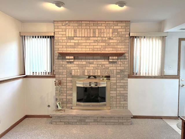 unfurnished living room featuring carpet, baseboards, and a fireplace