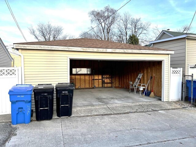 detached garage featuring fence