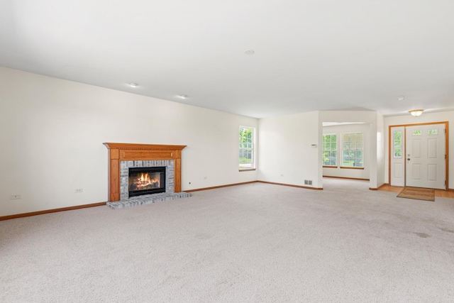 968 Pattee Ave, Elburn, IL 60119 - unfurnished living room featuring a fireplace, baseboards, and light colored carpet