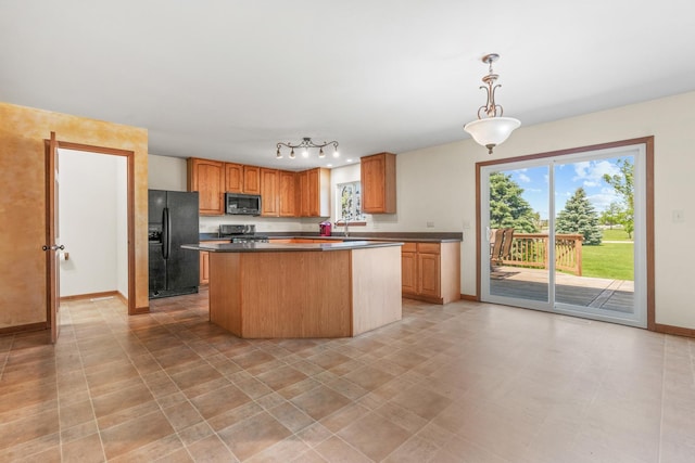 968 Pattee Ave, Elburn, IL 60119 - kitchen with stainless steel microwave, black refrigerator with ice dispenser, dark countertops, baseboards, and range