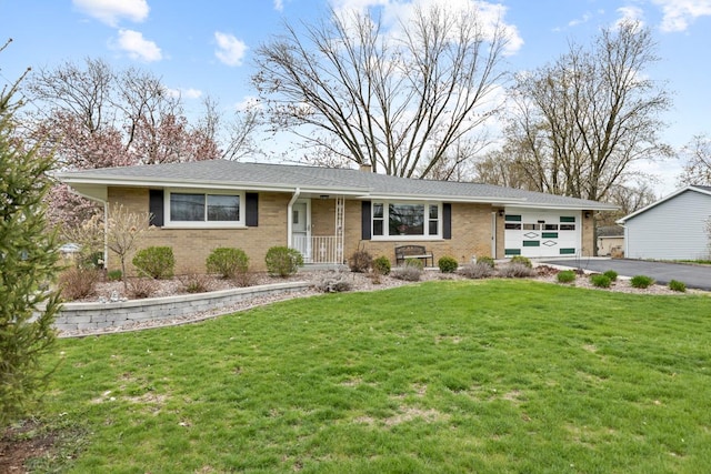 ranch-style home with a front yard, aphalt driveway, brick siding, and a garage