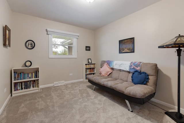 living area with baseboards, visible vents, and carpet floors