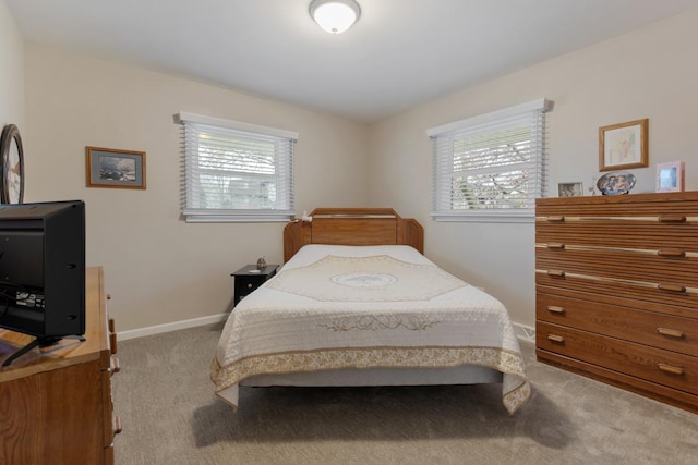 bedroom featuring carpet and baseboards