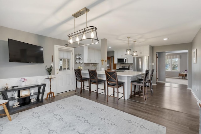 interior space with recessed lighting, baseboards, and dark wood-type flooring