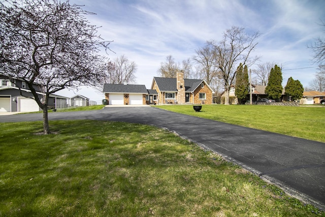 493 W Chebanse Ave, Chebanse, IL 60922 - view of front of home featuring a chimney, driveway, stone siding, and a front yard