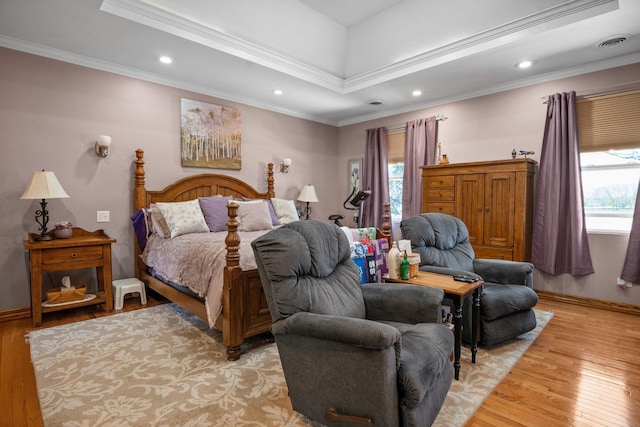 bedroom featuring visible vents, light wood finished floors, crown molding, and multiple windows