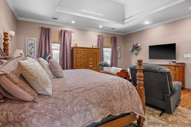 bedroom with visible vents, ornamental molding, wood finished floors, recessed lighting, and a raised ceiling