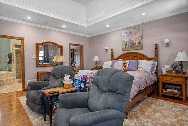 bedroom featuring a walk in closet, recessed lighting, wood finished floors, ornamental molding, and a closet