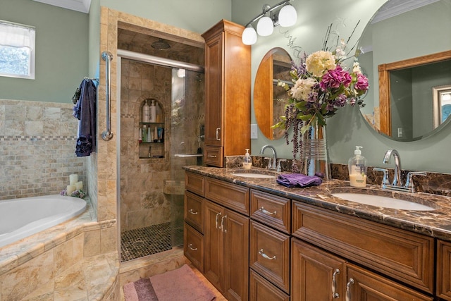 bathroom with a sink, crown molding, a shower stall, and a bath