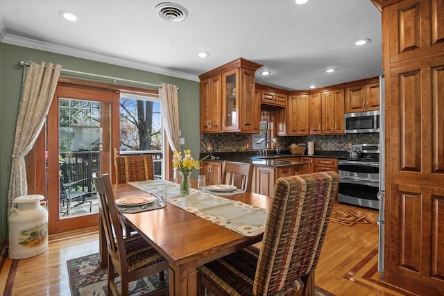 interior space featuring recessed lighting, visible vents, ornamental molding, and light wood-style flooring