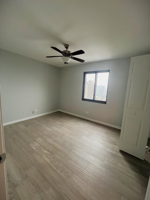 6150 N Kenmore Ave Unit 15B, Chicago, IL 60660 - empty room featuring wood finished floors, a ceiling fan, and baseboards