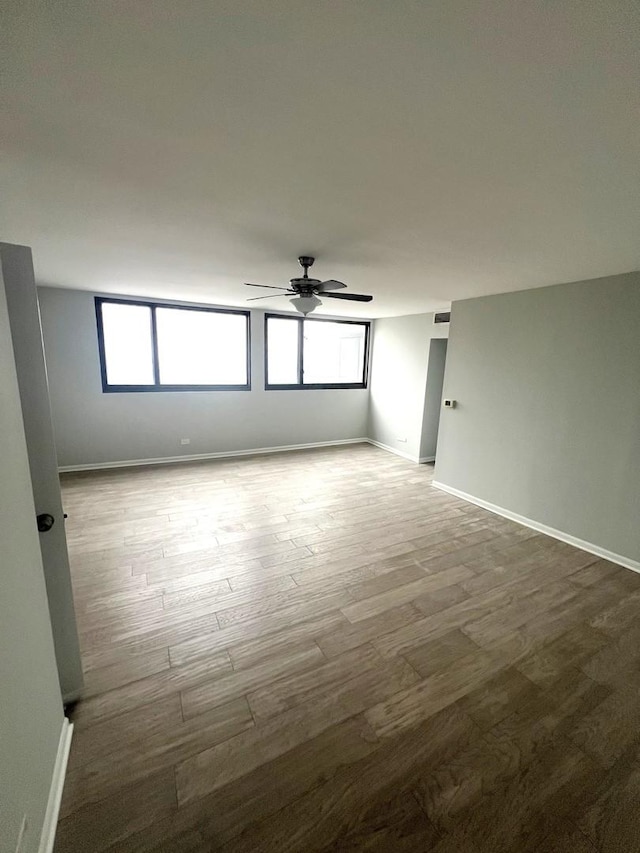 6150 N Kenmore Ave Unit 15B, Chicago, IL 60660 - empty room featuring a ceiling fan, healthy amount of natural light, wood finished floors, and baseboards