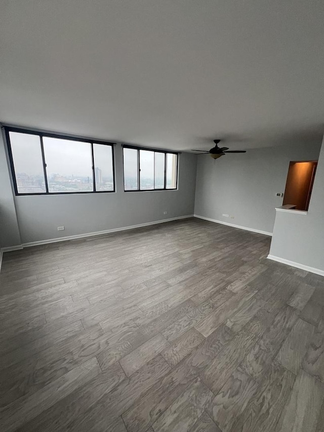 6150 N Kenmore Ave Unit 15B, Chicago, IL 60660 - unfurnished room featuring dark wood finished floors, a ceiling fan, and baseboards