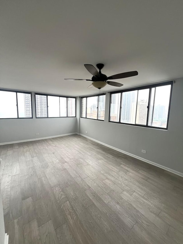 6150 N Kenmore Ave Unit 15B, Chicago, IL 60660 - empty room featuring a ceiling fan, wood finished floors, and baseboards