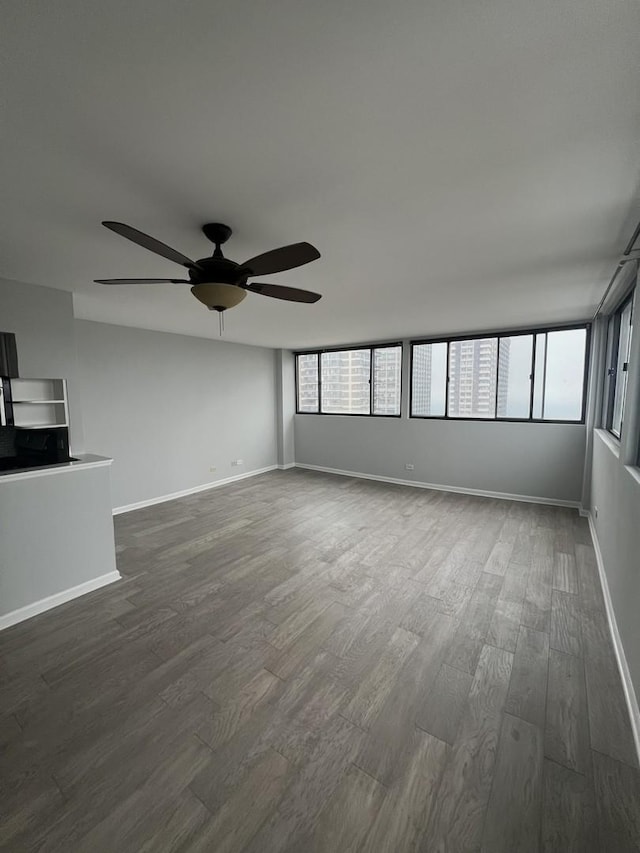6150 N Kenmore Ave Unit 15B, Chicago, IL 60660 - unfurnished living room featuring dark wood finished floors, a ceiling fan, and baseboards