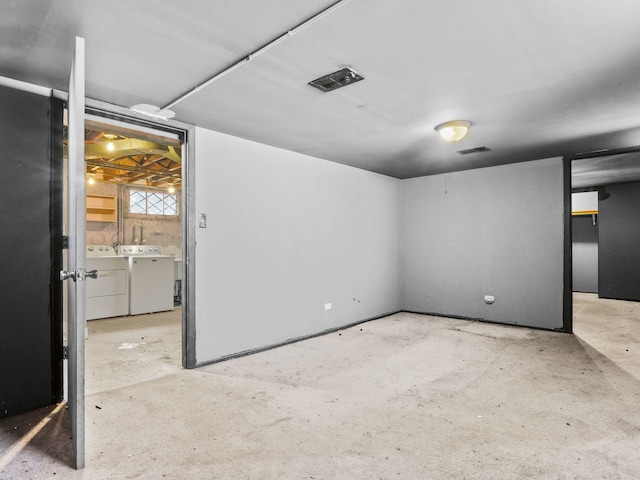 basement with visible vents and washer and clothes dryer