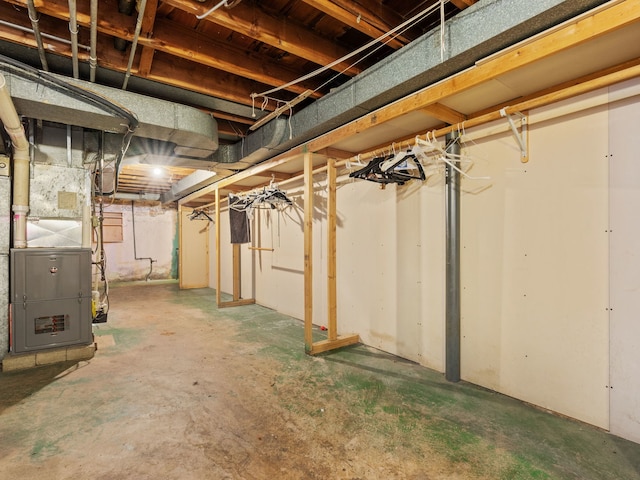 unfinished basement featuring heating unit