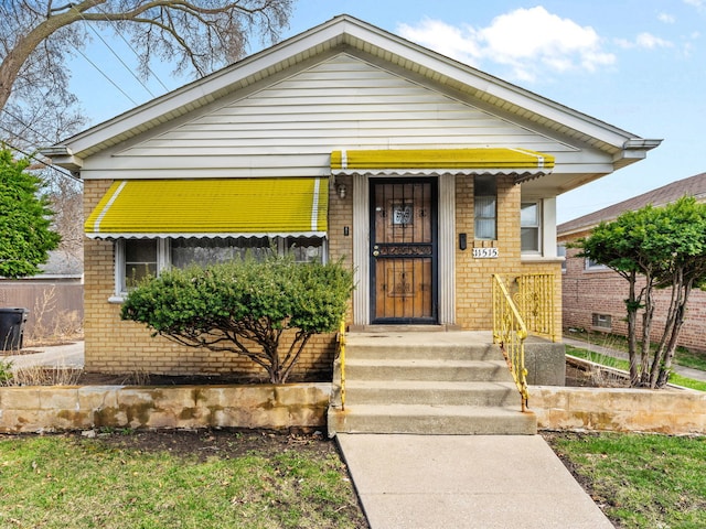 view of front of house featuring brick siding