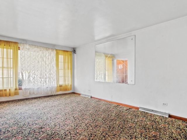 carpeted empty room with baseboards and visible vents