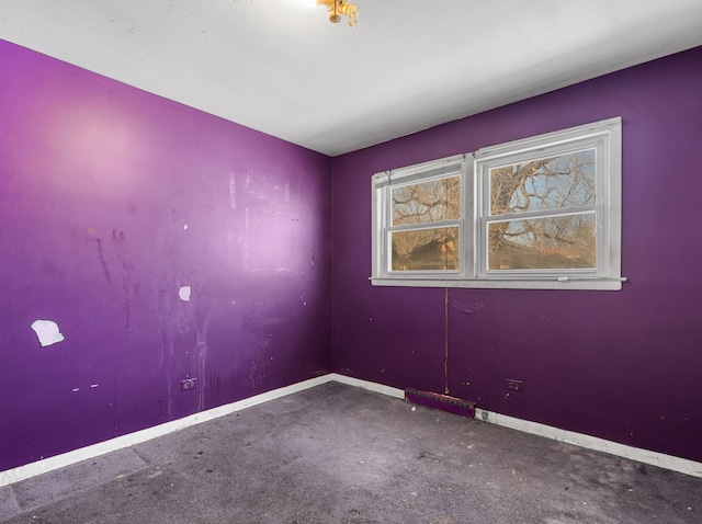 empty room featuring baseboards