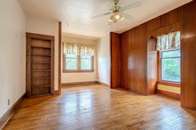 unfurnished bedroom featuring baseboards, ceiling fan, and wood-type flooring