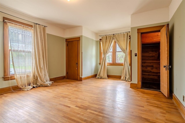 interior space with baseboards and light wood-style flooring