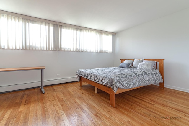 bedroom with baseboards and wood finished floors