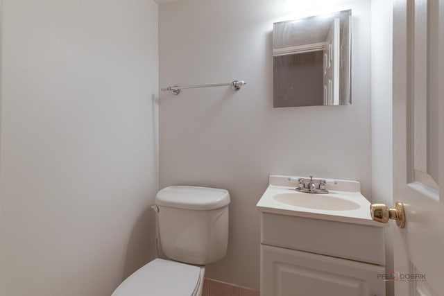half bath featuring toilet and vanity