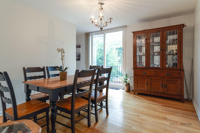 dining room featuring an inviting chandelier and light wood-style flooring