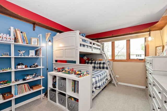 bedroom featuring baseboards and light carpet