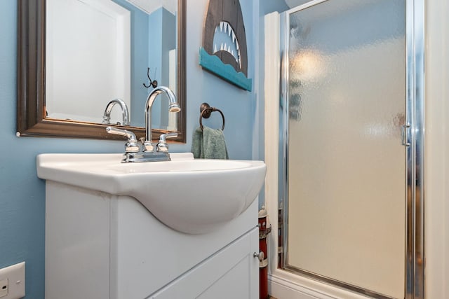 full bath with a stall shower and vanity