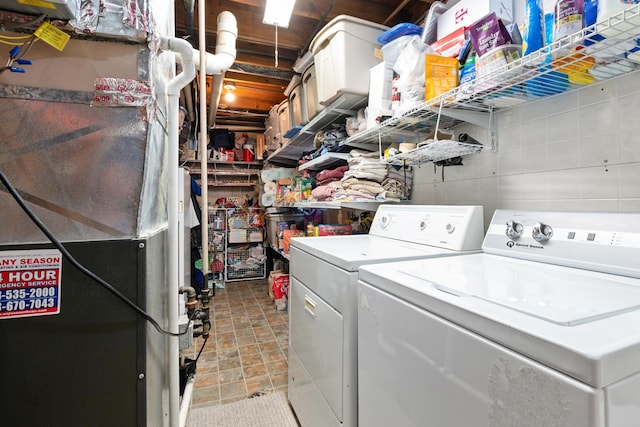 washroom with washing machine and clothes dryer and heating unit