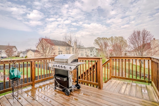 deck featuring area for grilling and a residential view