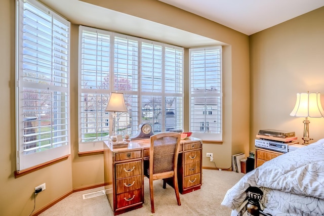 bedroom featuring baseboards, visible vents, and light colored carpet