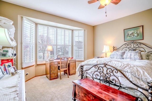 bedroom featuring light carpet, baseboards, and ceiling fan