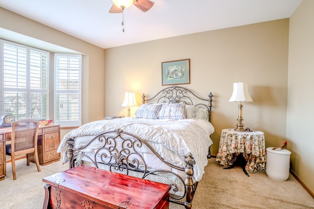 carpeted bedroom featuring baseboards and ceiling fan