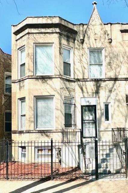 4024 W Polk St, Chicago, IL 60624 - view of building exterior featuring a fenced front yard