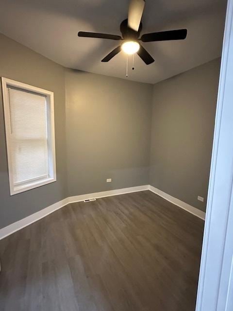 4024 W Polk St, Chicago, IL 60624 - spare room featuring dark wood-style flooring, ceiling fan, and baseboards