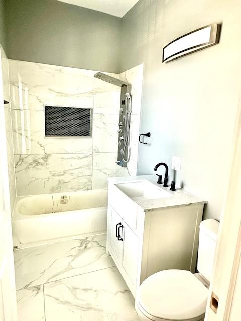 4024 W Polk St, Chicago, IL 60624 - bathroom with toilet, bathtub / shower combination, marble finish floor, and vanity