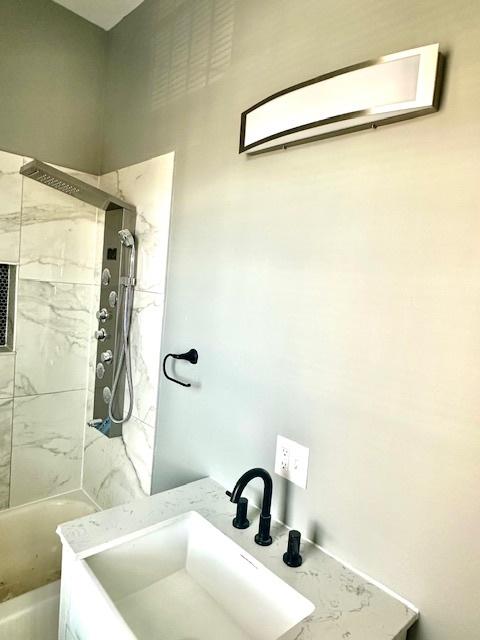 4024 W Polk St, Chicago, IL 60624 - bathroom featuring a bath, a sink, and walk in shower