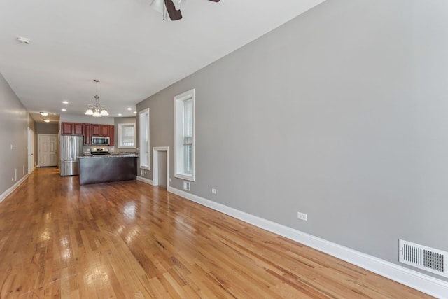 3220 W Polk St, Chicago, IL 60624 - unfurnished living room featuring a chandelier, ceiling fan, baseboards, light wood-type flooring, and recessed lighting