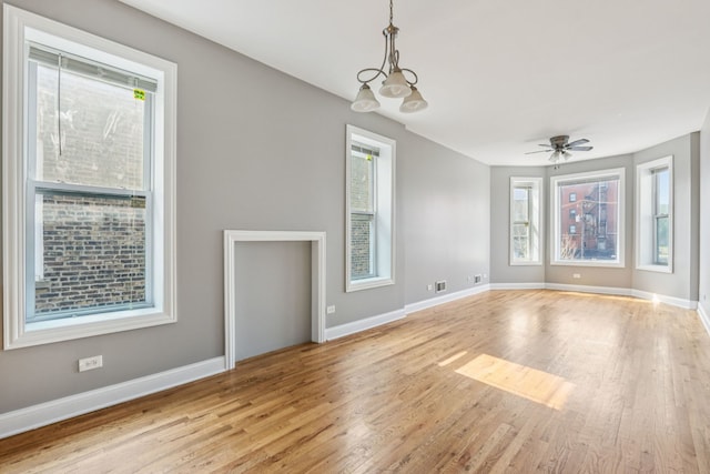 3220 W Polk St, Chicago, IL 60624 - unfurnished living room with wood finished floors, baseboards, and a ceiling fan