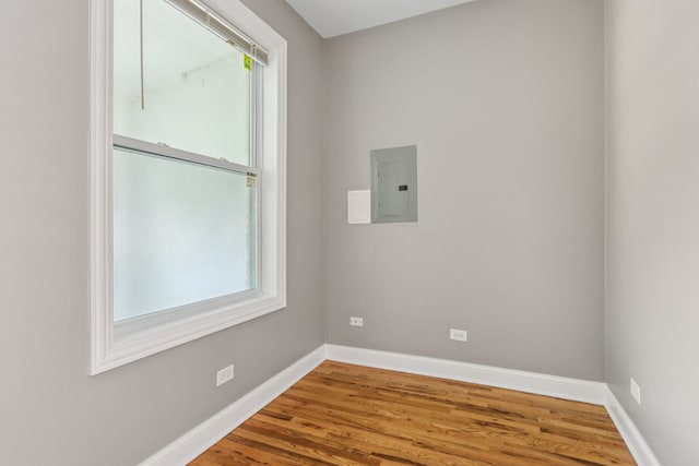 3220 W Polk St, Chicago, IL 60624 - spare room with electric panel, baseboards, plenty of natural light, and wood finished floors