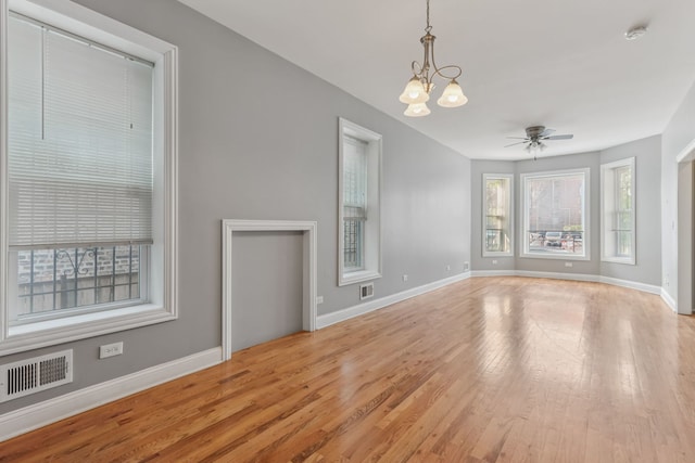 3220 W Polk St, Chicago, IL 60624 - unfurnished living room with light wood-style floors, baseboards, and a chandelier