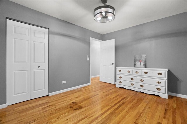 24860 W Forest Dr, Lake Villa, IL 60046 - unfurnished bedroom with light wood-type flooring, baseboards, and a closet