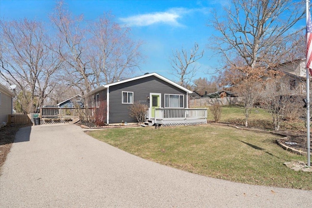 24860 W Forest Dr, Lake Villa, IL 60046 - view of front of house with asphalt driveway, a deck, and a front lawn