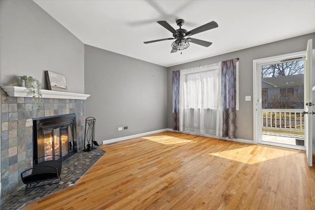 24860 W Forest Dr, Lake Villa, IL 60046 - unfurnished living room featuring wood finished floors, baseboards, a tiled fireplace, and ceiling fan